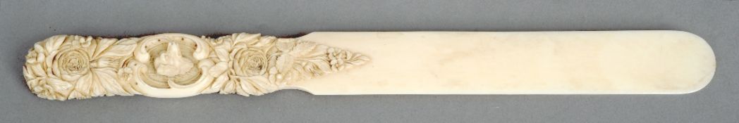 A 19th century carved ivory paper knife
The handle with profuse floral decoration, each side with
