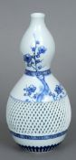 A 19th century Oriental blue and white double gourd vase
Decorated with prunus blossoms and a band