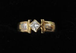 An 18 ct gold quarter carat Princess cut diamond ring
Supported by T-bars.   CONDITION REPORTS: