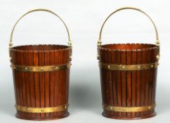 A pair of 18th century style brass bound mahogany buckets
Each with a brass swing handle above the