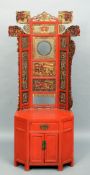 A Chinese lacquered hall chair
Profusely pierced and carved with various figural and scrolling