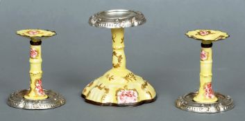 A 19th century Vienna enamelled candlestick
Mounted with an unmarked white metal sconce; together