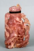 A 19th century Chinese rose quartz vase and cover
Carved with a figure and birds amongst foliage,