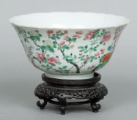 A 19th century Chinese famille verte bowl
Of scalloped form, decorated with blossoming foliage,