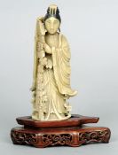 A Chinese carved hardstone figure of Guanyin
Modelled in flowing gowns within a garland of