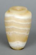 An Egyptian alabaster storage jar
The squat neck rim above the main tapering body.  13 cms high.