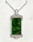 A fine quality jade and diamond pendant set in 14 ct white gold and a 14 ct white gold chain
The