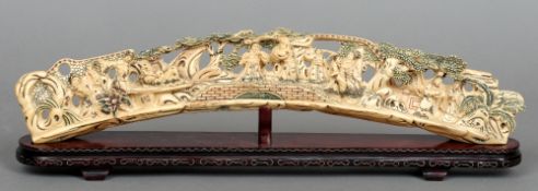 A Chinese ivory tusk carving
Formed as courtly figures in a landscape, with painted decoration,