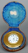 A Victorian cased travelling clock
Of banded circular form, the white enamelled dial with Roman