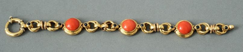 An 18 ct gold bracelet
Set with cabochon, coral and sapphires.  19 cms long.   CONDITION REPORTS: