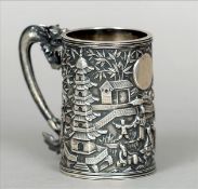 A 19th century Chinese silver tankard The embossed cylindrical body decorated with figures and