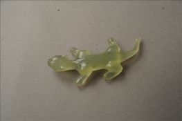 A carved jade model of a lizard Naturalistically modelled. 7.5 cms long. Some fritting, chip to