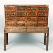 A 19th century Indo-Portuguese padouk table cabinet The panelled rectangular top cornered with