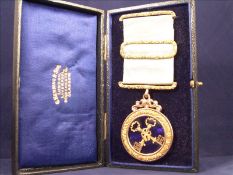 A Victorian yellow metal cased and blue enamelled masonic medal Centred with ribbon tied crossed