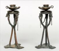 A pair of 19th century Grand Tour bronze candlesticks Each lamp form finial supported by three