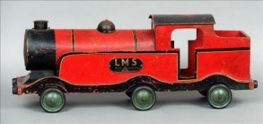A 1930s Lines Brothers painted wood and papier mache locomotive Of typical form, in red and black