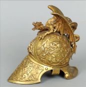 A 19th century gilt bronze inkwell Formed as a helmet, with overall cast decoration, the hinged