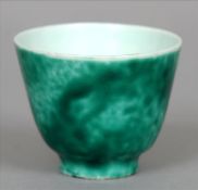 A Chinese porcelain wine cup With allover mottled green glaze, unmarked. 5.5 cms high. Fritting to