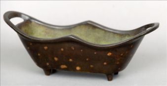 A Chinese patinated bronze censor Of navette form, with pierced handles, the underside with cast