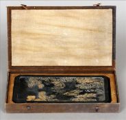 A Chinese ink slab Of canted rectangular form and carved with scholarly figures and sages in a