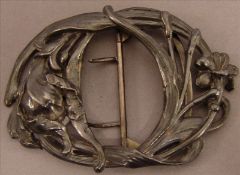 An Art Nouveau Continental white metal buckle Of stylised organic form. 9 cms wide. Slight splitting