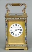 A French cloisonne decorated brass cased carriage clock The scrolling handle above the white