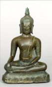 An Antique patinated bronze Buddha Typically modelled seated in the lotus position. 14.5 cms high.