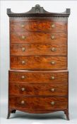 An early 19th century mahogany bow fronted chest on chest The shaped cornice centred with a carved