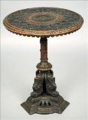 A painted cast iron side table The removable florally decorated pierced top above the reeded and