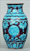 A 19th century Chinese vase The purple ground with blue scrolling and geometric decoration. 20 cms