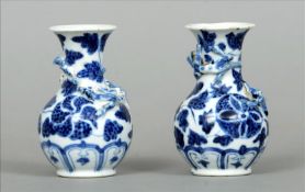 A small pair of 19th century Chinese blue and white vases Each decorated in relief with two