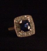 A platinum diamond and sapphire cluster ring The central sapphire encircled by twelve brilliant