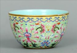 An enamel decorated Chinese tea bowl The gilt rim above a band of lappet decoration, the main body