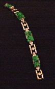 An Art Deco 18 ct white gold bracelet With carved spinach jade floral tablets alternating with