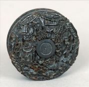 A 19th century Chinese tortoiseshell snuff box and cover Of circular section and deeply carved