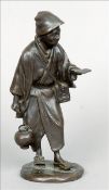 A Meiji period Japanese bronze figure Formed as a butterfly catcher, the base with cast seal mark.