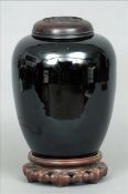 A 19th century Chinese famille noir ginger jar and cover Of baluster form, the cover pierced and
