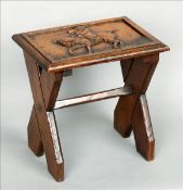 A 19th century carved oak stool The top decorated with a horse with huntsman up, above an X-frame