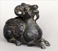 A Chinese patinated bronze model of a winged goat Modelled in recumbent position. 16.5 cms long.