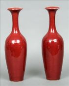A pair of Chinese porcelain flambe glazed bottle vases Each with flared rim, slender neck and