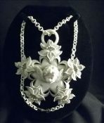 A French ivorine pendant Florally decorated star form centred with a cherub mask suspended on an
