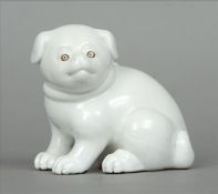 A 19th century blanc de chine model of a dog Naturalistically modelled on all fours wearing a bow.
