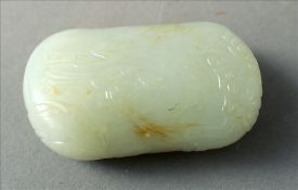 An 18th century Chinese celadon jade carved pebble Decorated with scholarly figures in a mountainous
