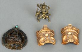 Two Tibetan carved bone effigy masks Together with a small Tibetan copper plaque of Buddha in