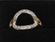 An 18 ct gold and diamond designer ring Set with a circle of diamonds, the shoulders inscribed