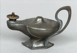 An Art Nouveau WMF pewter oil lamp The scrolling handle above twin apertures, standing on an angular