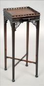 A 19th century mahogany kettle stand The pierced galleried top above a blind fret carved frieze with