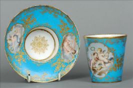 A 19th century Sevres style cup and saucer The blue ground with trailing gilt decoration and