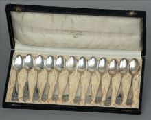 A cased set of twelve Norwegian silver teaspoons, marked 830, maker’s mark of NM Each with shell