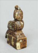 Two Chinese carved mottled green jade seals One surmounted with the figure of a harpy, the other